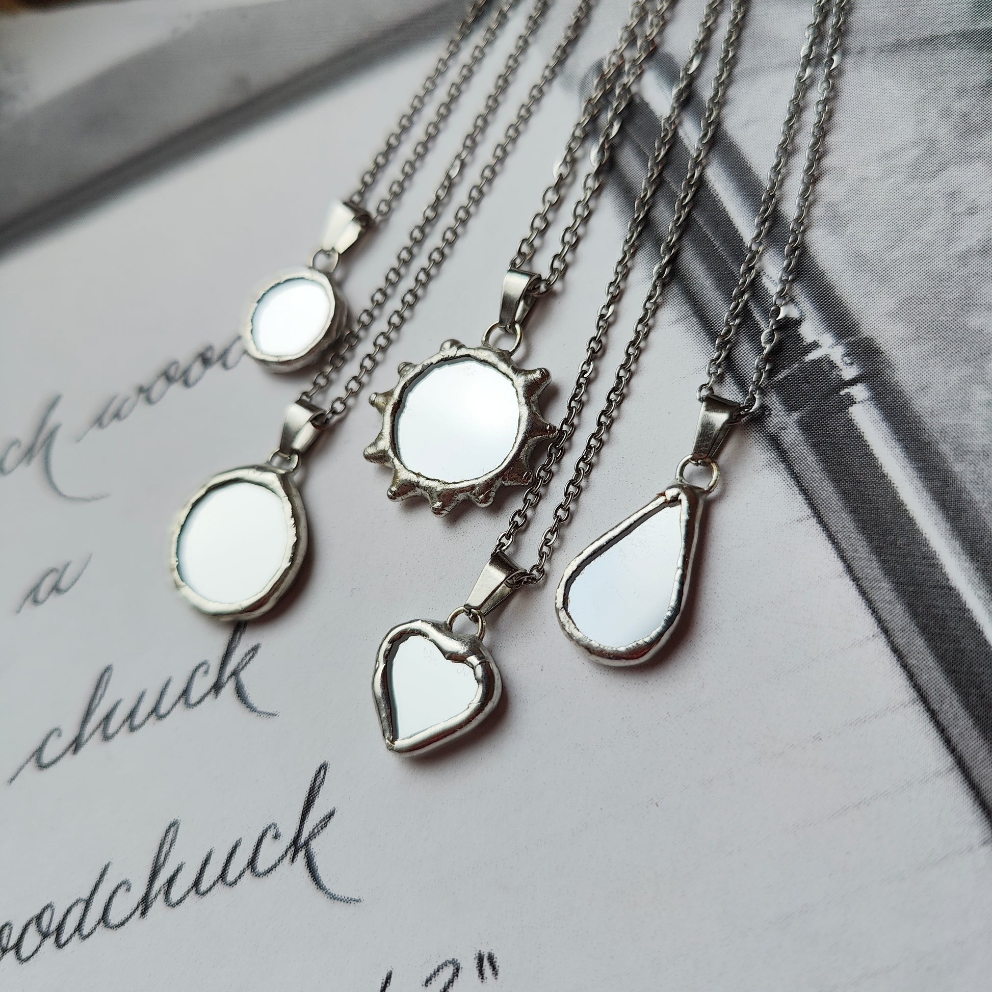 Minimalist mirror amulet necklaces in sun, heart, teardrop, round and oval shapes – handmade stained glass jewelry by HelenkaBee, witchcore and celestial gift idea